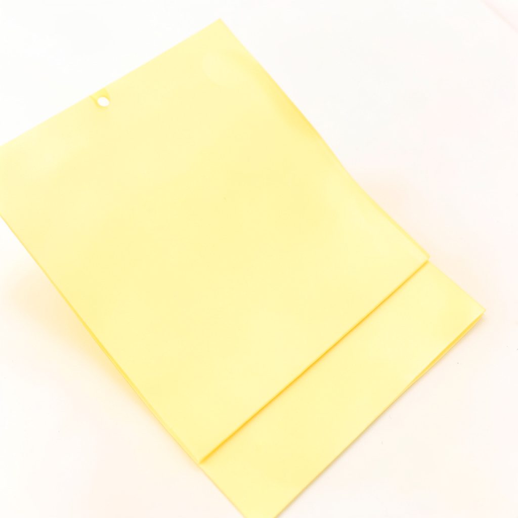 Bright yellow monogram product detail on clean white background